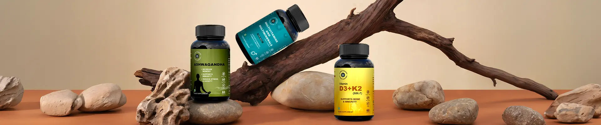 Three bottles of supplements on a wooden surface with rocks and a branch.